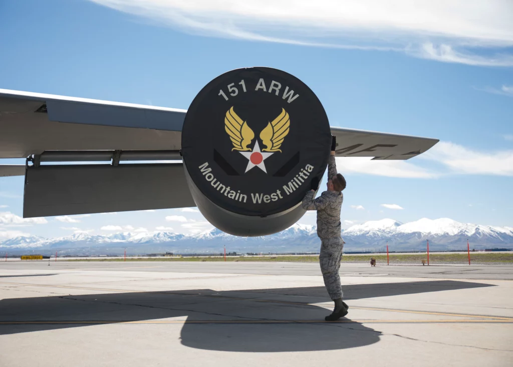 Utah Air National Guard, Mountain West Militia, 151st Air Refueling Wing plane wing with logo on airstrip and mountains in the background.