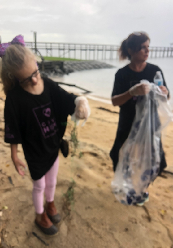 Debbie Morgan and Holin Saucer picking up trash on the beach.