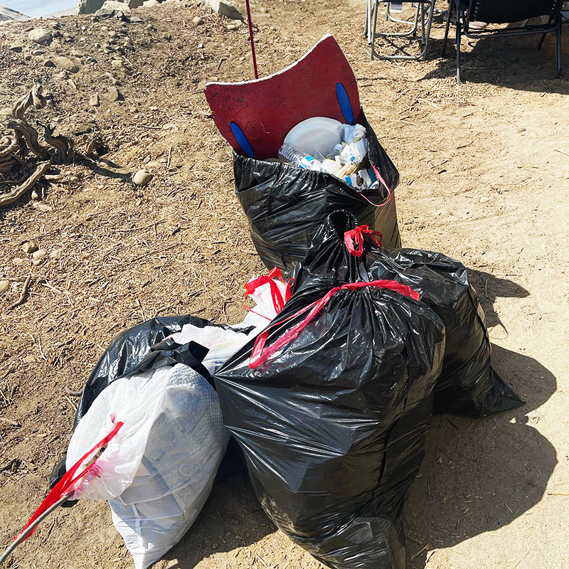Several bags of trash that was collected from the beach by volunteers