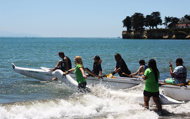 People kayaking in the ocean.