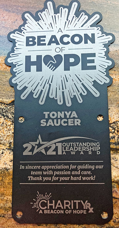 Meet CharityRx Rep Tonya Saucer - A black CharityRx Beacon of Hope award plaque, with silver metallic text and design, highlights Tonya Saucer for the 2021 Outstanding Leadership Award