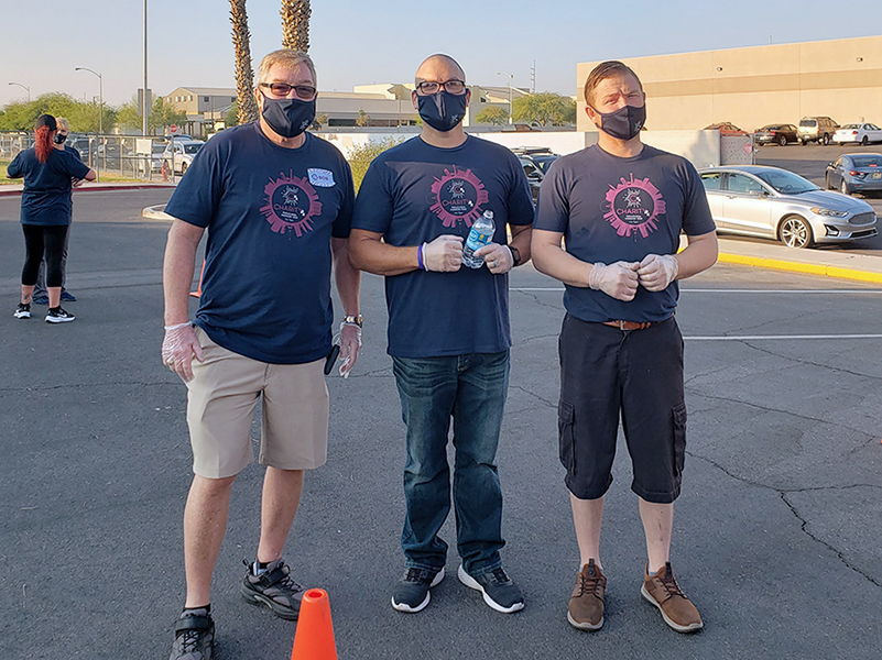 Meet CharityRx Rep David Gingrass. Image: Three middle-aged men stand outside in a parking lot. They are wearing face masks and matching t-shirts.