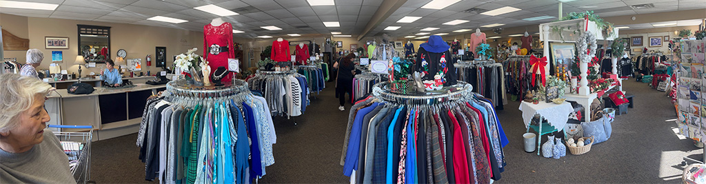 Image of the inside of a thrift store with many round racks of clothing, mannequins, shelves and racks of product. CharityRx Supports Women and Children