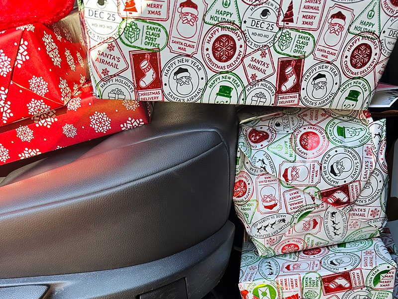 Image of wrapped gifts in the back seat of a car