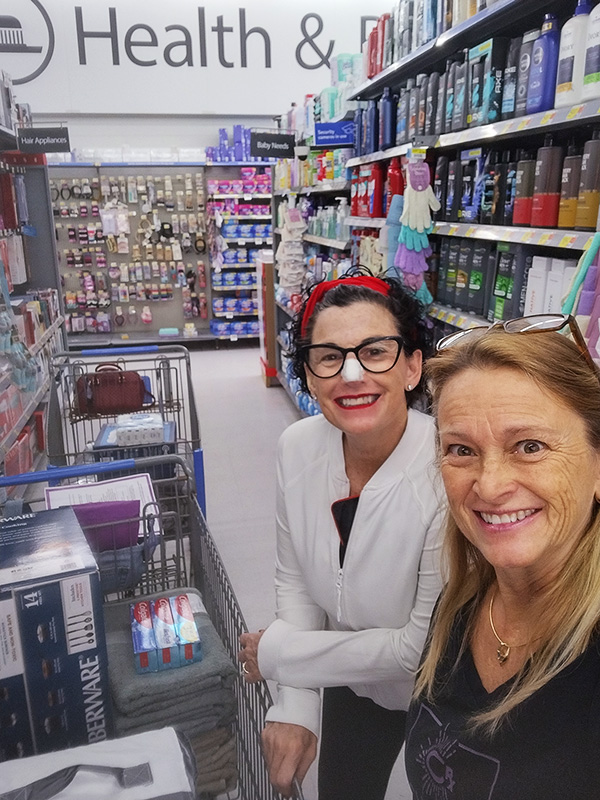 Image of two women shopping for household and personal care items to be donated to the Women's Center of Brevard. CharityRx Supports Women and Children