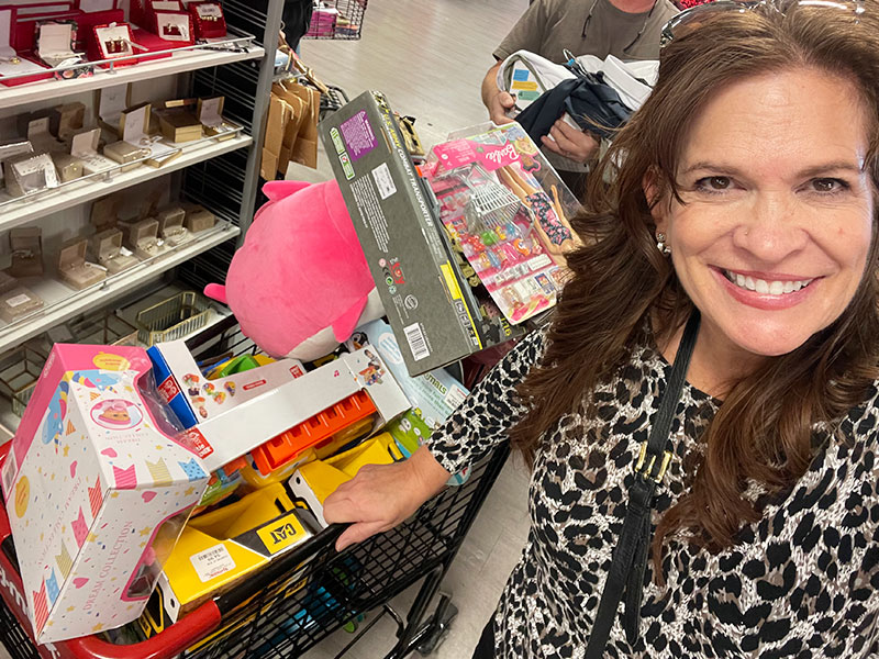 Image of a woman shopping for toys to donate.