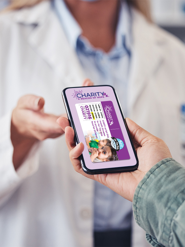 Image of a person handing their smart phone to a pharmacist. The image on the phone is the CharityRx Prescription Discount Card.