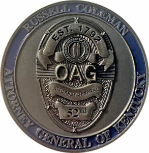 Image of a coin with shield design from the Office of the Kentucky Attorney General